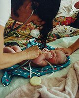 Midwife Listening to Newborn's Heartbeat