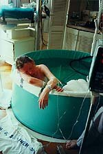 woman laboring in birthing tub